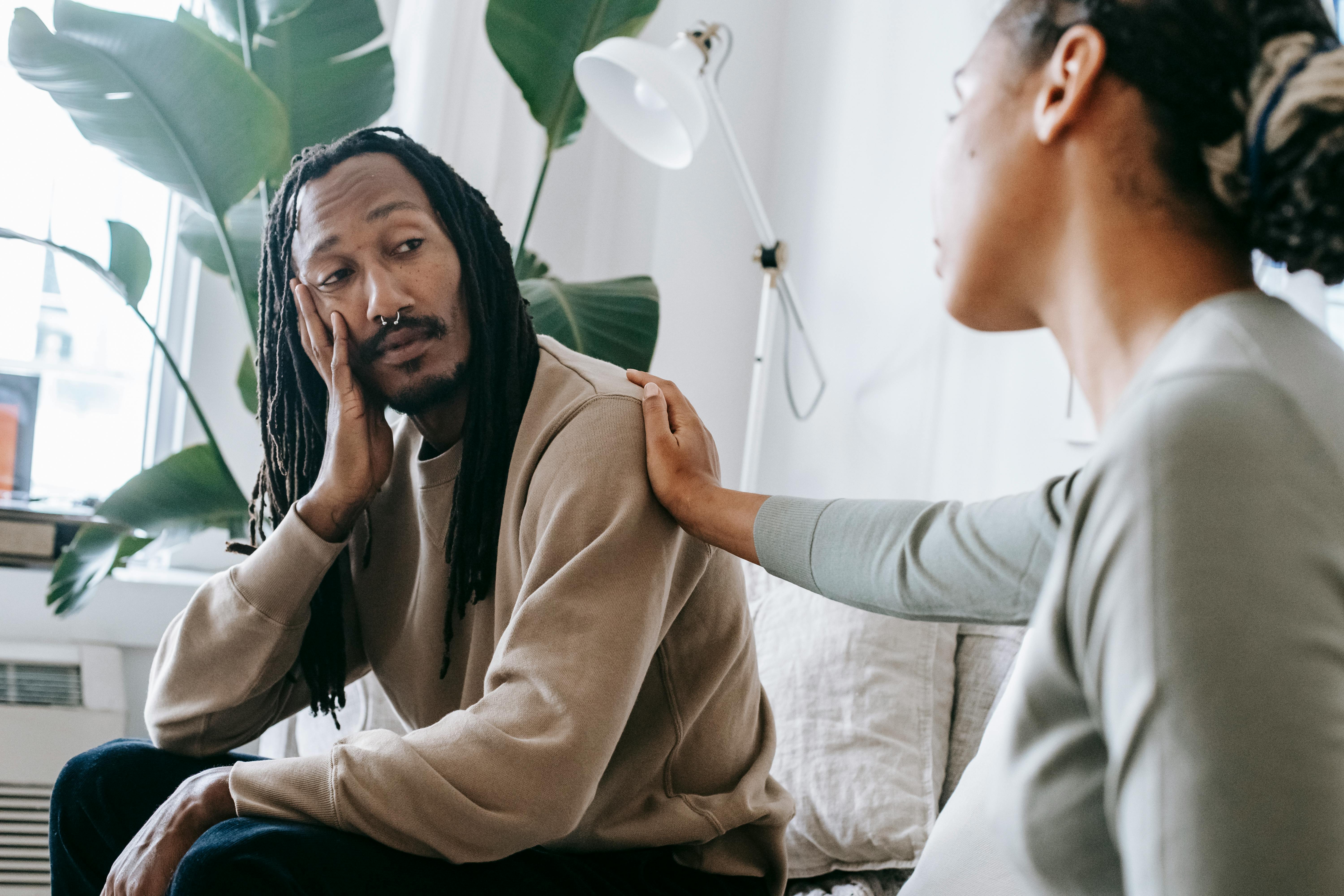 A supportive conversation between a therapist and a Black male client.